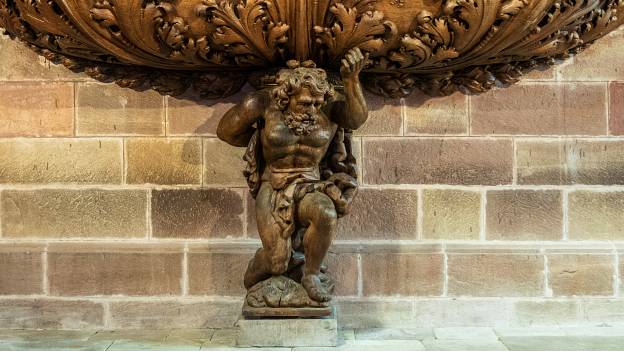 Atlas carrying the organ of Abbatiale Saint-Pierre et Saint-Paul